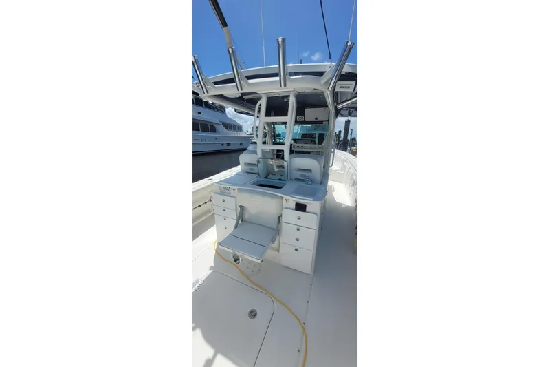 Slide: The Image of 2009 Everglades 350 Center Console boat on calm water, featuring spacious seating and modern design. - 9