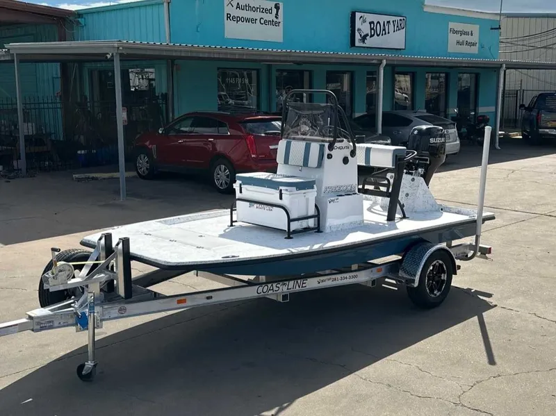 The Image of 2026 Freedom CHIQUITA boat on trailer outside workshop. - 1