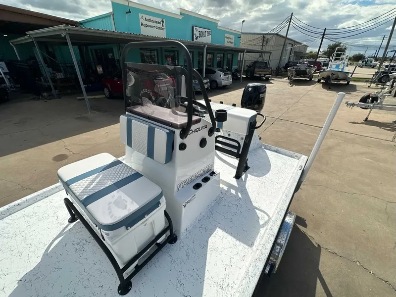 Slide: The Image of 2026 Freedom CHIQUITA boat parked outside a repair center. - 14