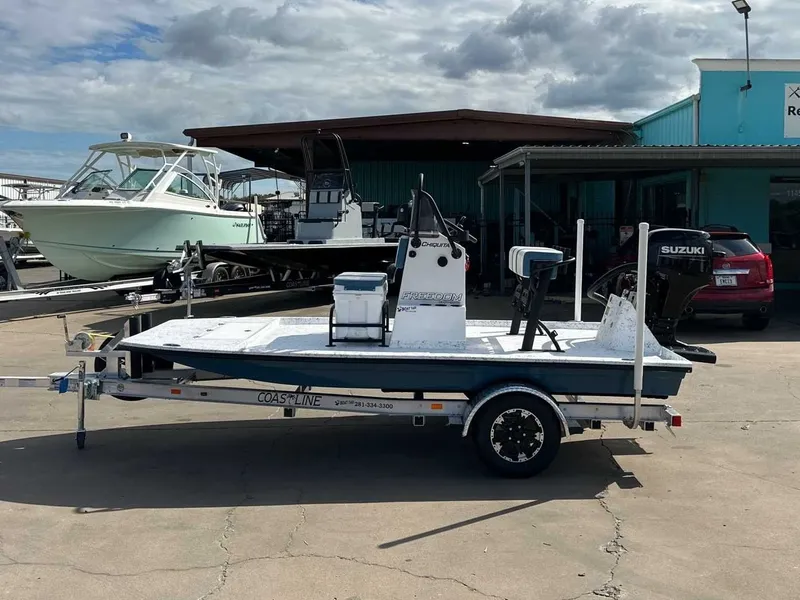 Slide: The Image of Freedom CHIQUITA 2026 boat on trailer in front of a building. - 2