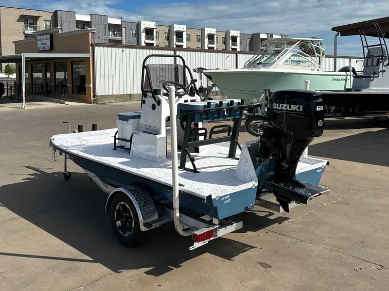 Slide: The Image of 2026 Freedom CHIQUITA boat with Suzuki engine on trailer. - 3