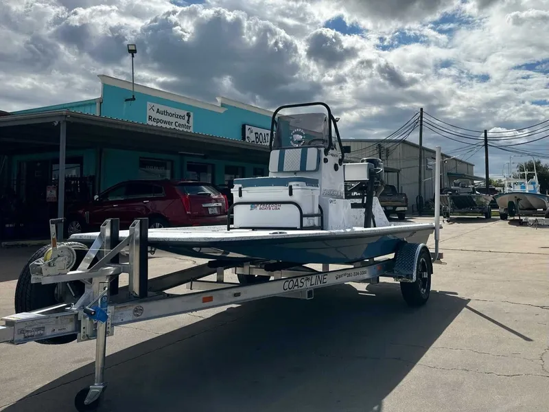 Slide: The Image of 2026 Freedom CHIQUITA boat on trailer outside workshop. - 8