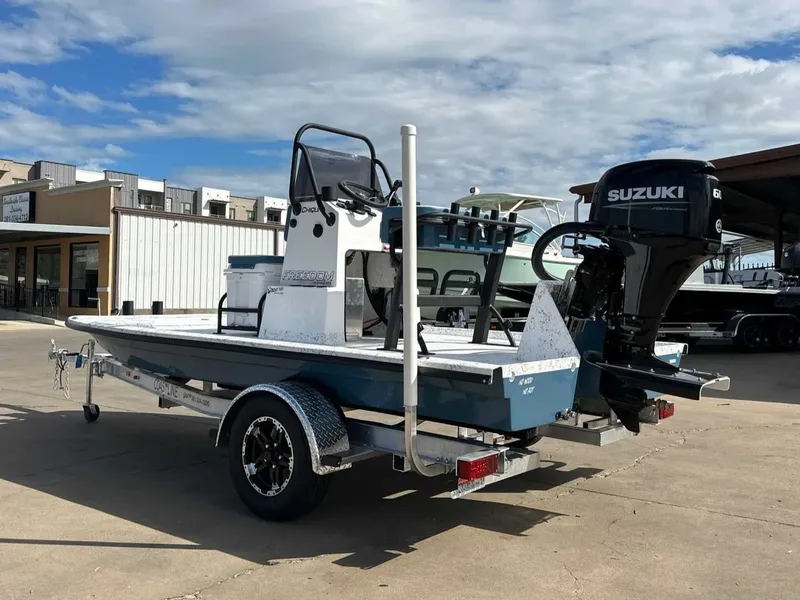 Slide: The Image of 2026 Freedom CHIQUITA boat with Suzuki engine on trailer. - 9