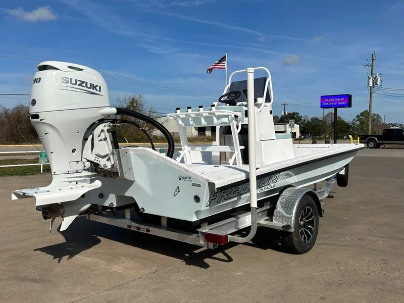Slide: The Image of 2026 Freedom EAGLE boat with Suzuki engine on trailer. - 11