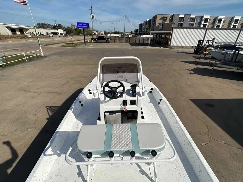 Slide: The Image of 2026 Freedom EAGLE boat on parking lot with buildings in background. - 12