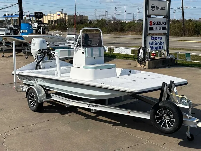 Slide: The Image of 2026 Freedom EAGLE boat on trailer at Suzuki Marine dealer. - 6