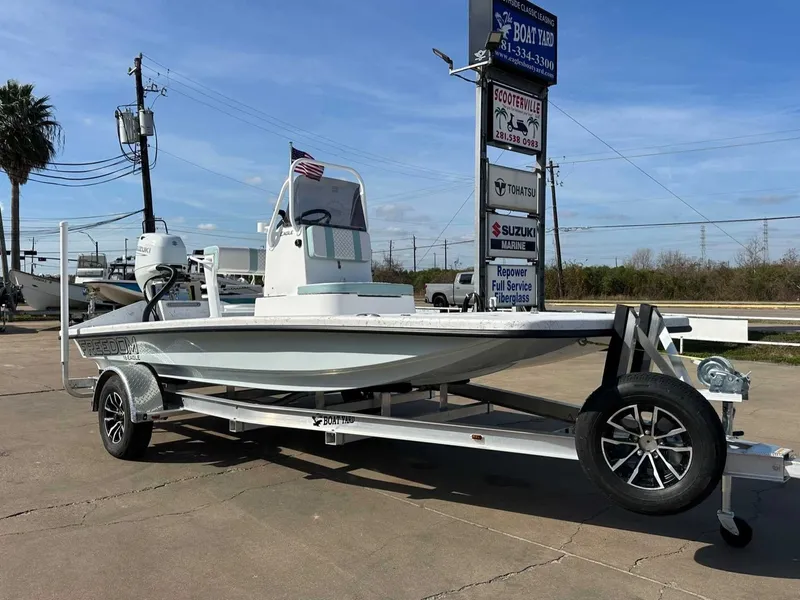 Slide: The Image of 2026 Freedom EAGLE boat on trailer outdoors. - 7