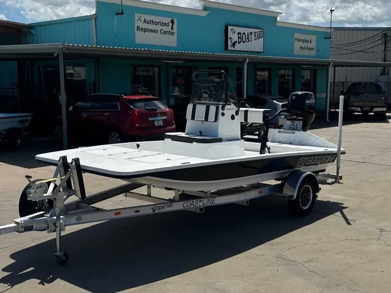 The Image of 2026 Freedom EAGLE boat on trailer outside workshop. - 1