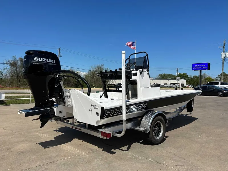 Slide: The Image of 2026 Freedom EAGLE boat with Suzuki engine on trailer. - 10
