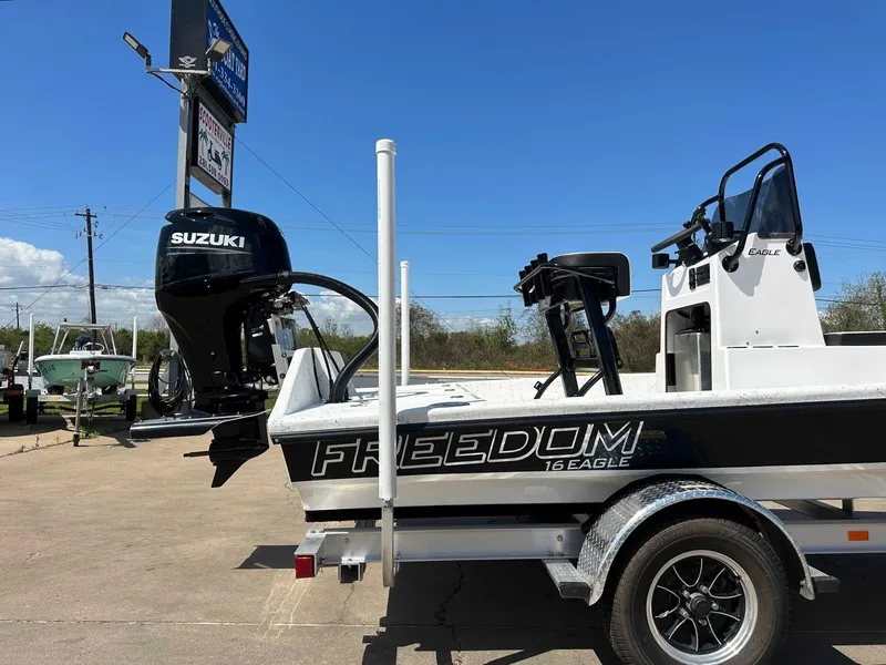 Slide: The Image of Freedom EAGLE 2026 boat with Suzuki engine on trailer. - 11