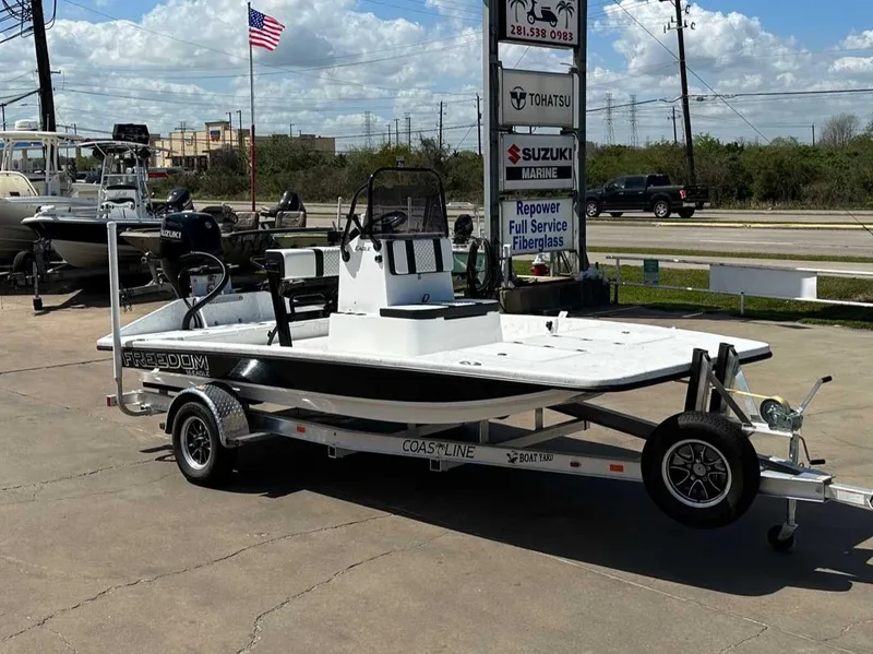 Slide: The Image of 2026 Freedom EAGLE boat on trailer at Suzuki Marine dealer. - 6