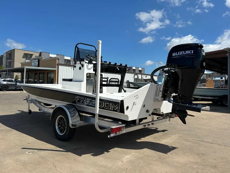 Slide: The Image of 2026 Freedom EAGLE boat with Suzuki engine on trailer. - 9