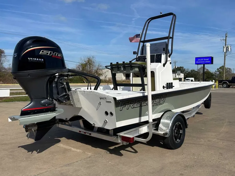 Slide: The Image of 2026 Freedom PATRIOT boat with Yamaha engine on trailer. - 11