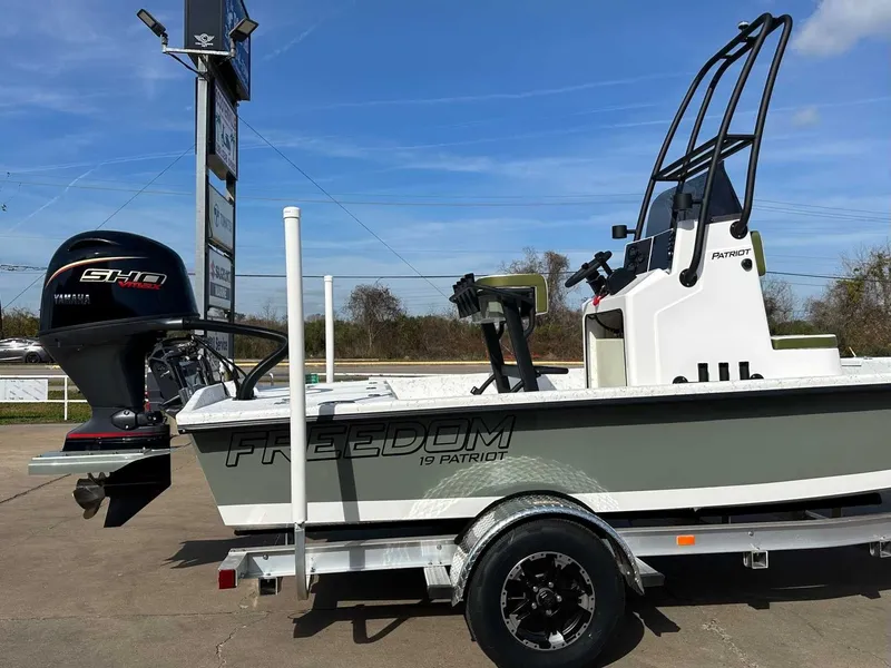 Slide: The Image of 2026 Freedom PATRIOT boat with Yamaha engine on trailer. - 12