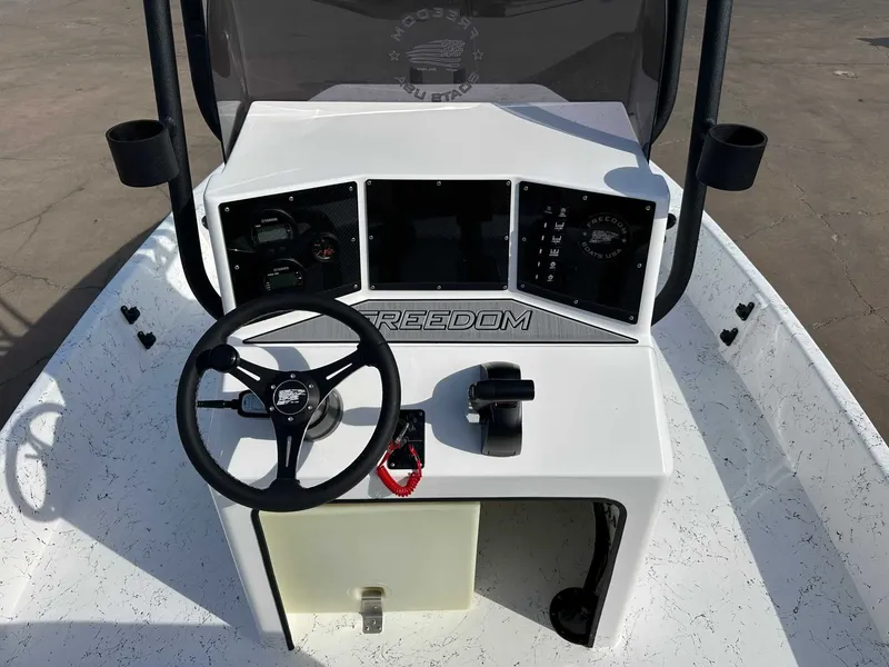 Slide: The Image of Interior view of Freedom PATRIOT 2026 boat with steering console. - 14