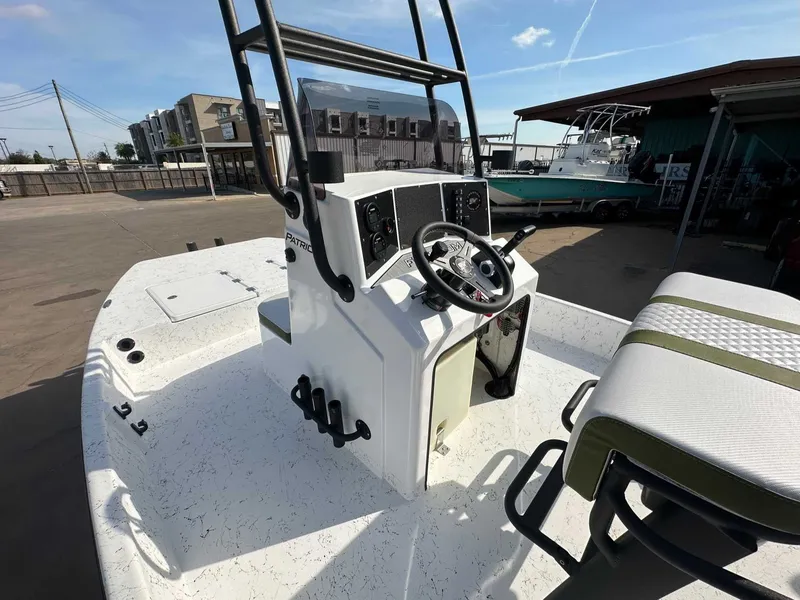 Slide: The Image of 2026 Freedom PATRIOT boat with steering console outdoors. - 15