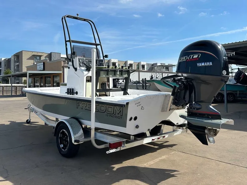 Slide: The Image of 2026 Freedom PATRIOT boat with Yamaha engine on trailer. - 9