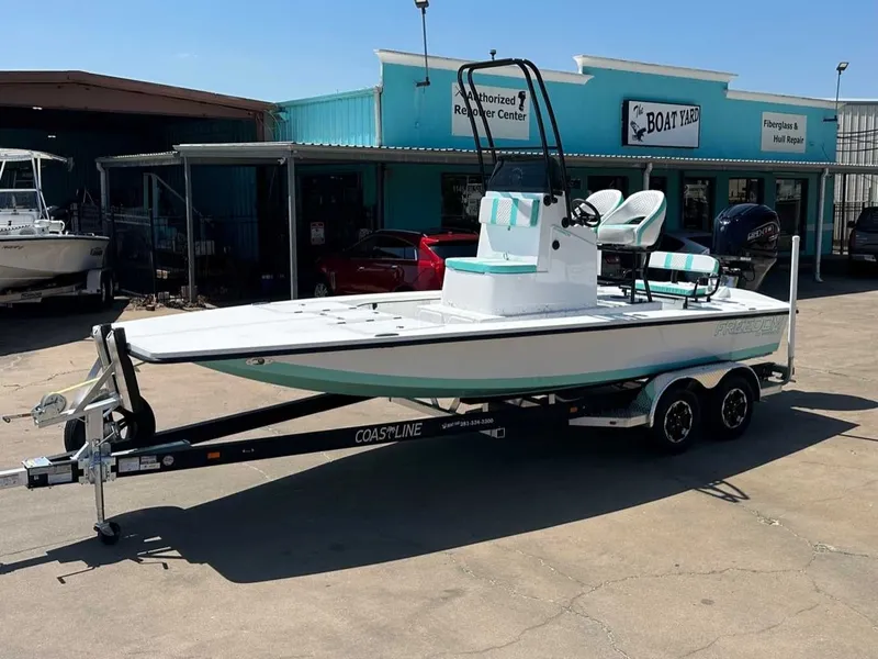 The Image of 2026 Freedom Warrior boat on trailer outside workshop. - 1