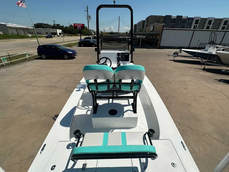 Slide: The Image of Freedom Warrior 2026 boat with turquoise seats on a parking lot. - 14