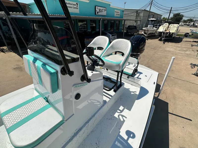 Slide: The Image of Freedom Warrior 2026 boat with turquoise and white seats outdoors. - 21
