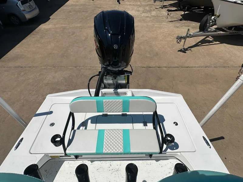 Slide: The Image of Freedom Warrior 2026 boat with outboard motor and bench seat. - 23