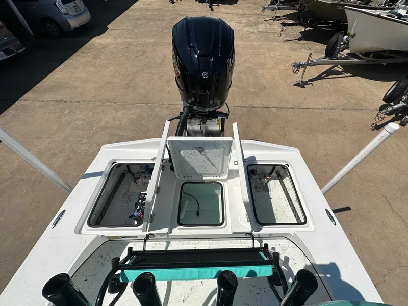 Slide: The Image of 2026 Freedom Warrior boat with open storage compartments and outboard motor. - 24