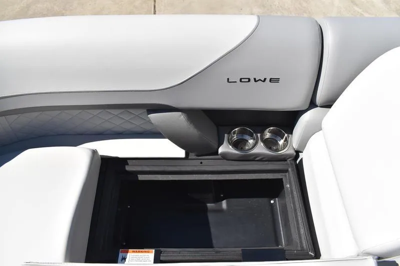 Slide: The Image of 2026 Lowe SS 230 boat interior with storage compartment and cup holders. - 14