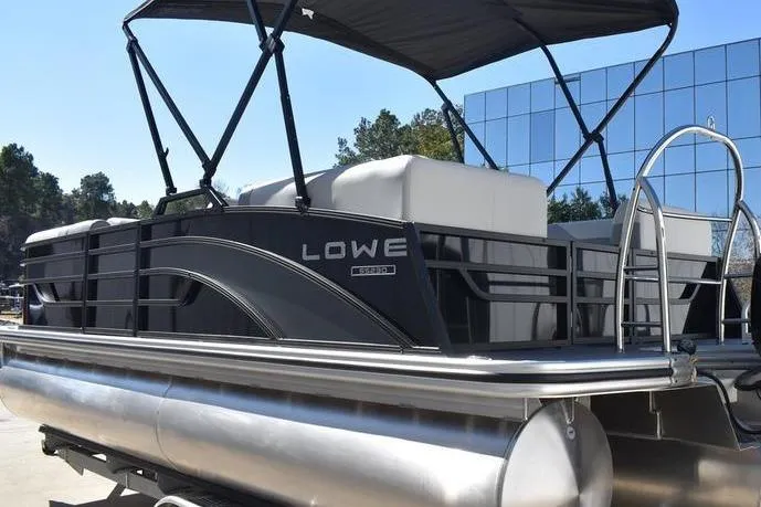 Slide: The Image of 2026 Lowe SS 230 pontoon boat with canopy, docked outdoors. - 17