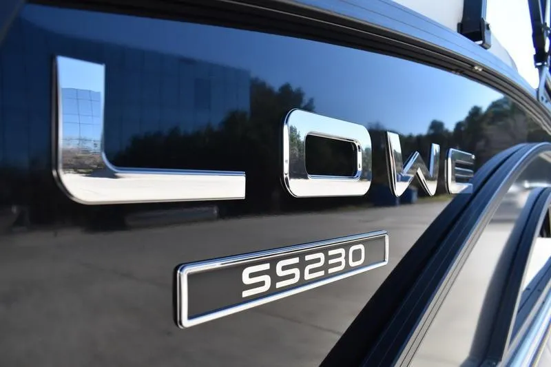 Slide: The Image of Close-up of 2026 Lowe SS 230 boat logo on a sleek, reflective surface. - 19