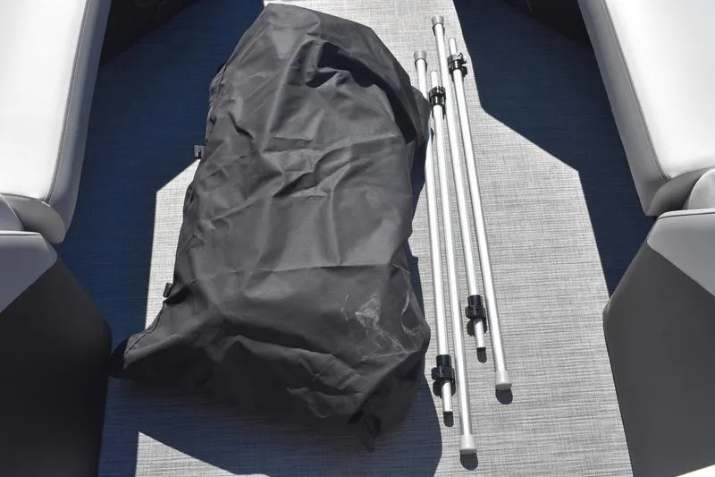 Slide: The Image of Boat interior with black bag and metal poles, Lowe SS 230, 2026 model. - 2