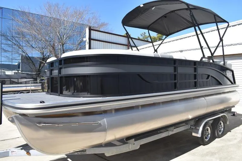 Slide: The Image of 2026 Lowe SS 230 pontoon boat on trailer with canopy, parked outdoors. - 20