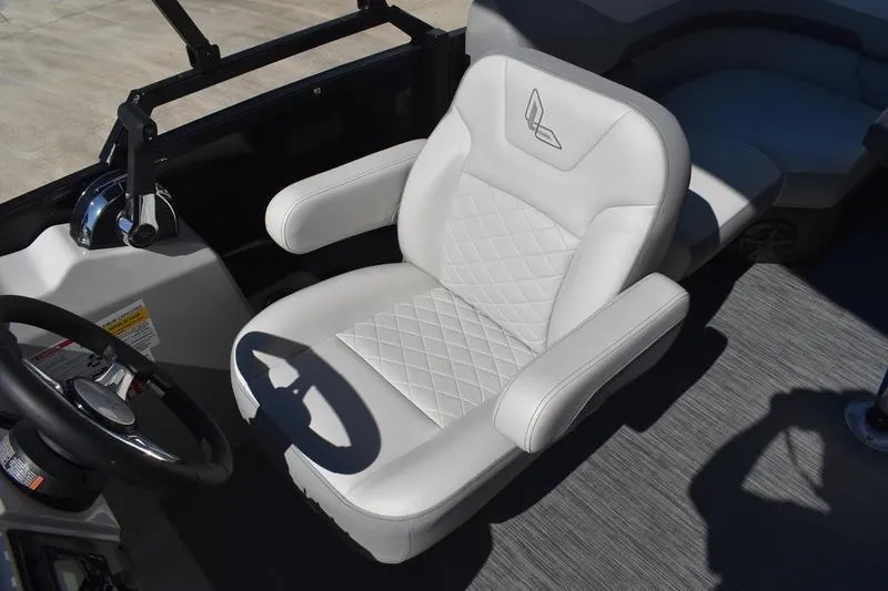 Slide: The Image of Captain's chair in 2026 Lowe SS 230 boat, featuring white upholstery and diamond stitching. - 25