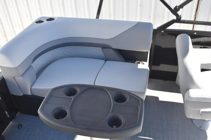 Slide: The Image of 2026 Lowe SS 230 boat interior with gray seating and cupholder table. - 30