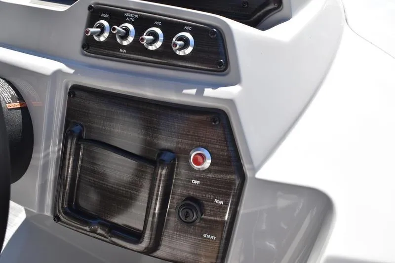 Slide: The Image of Control panel of 2026 Lowe SS 230 boat with switches and start button. - 32