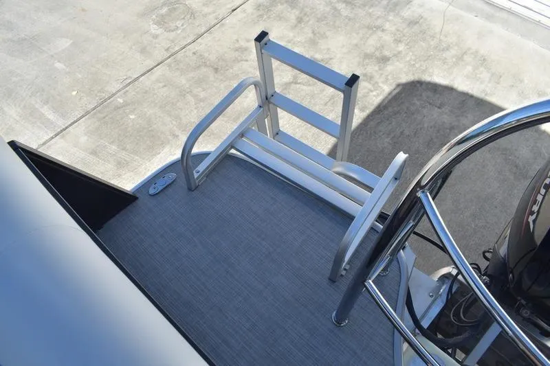 Slide: The Image of Aluminum ladder on 2026 Lowe SS 230 boat deck, with outboard motor visible. - 39