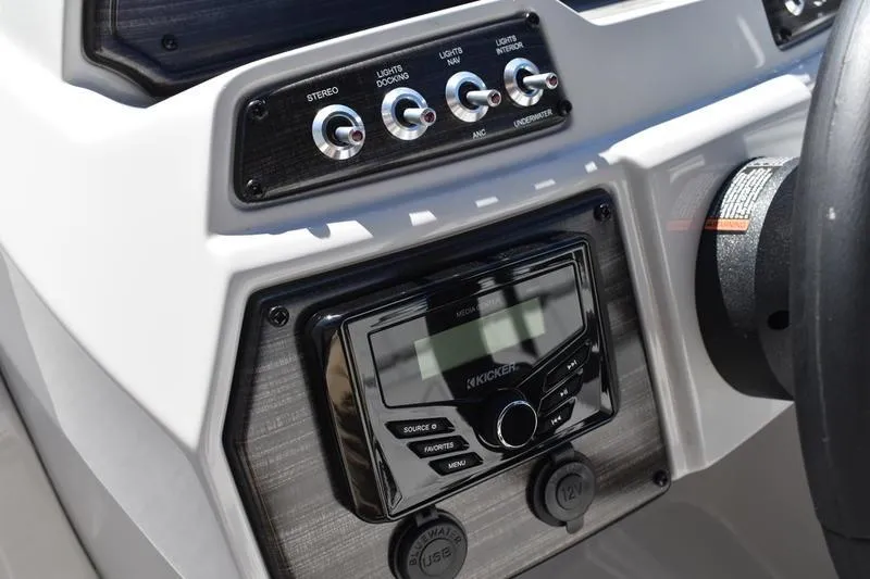 Slide: The Image of Control panel of 2026 Lowe SS 230 boat with stereo and light switches. - 42