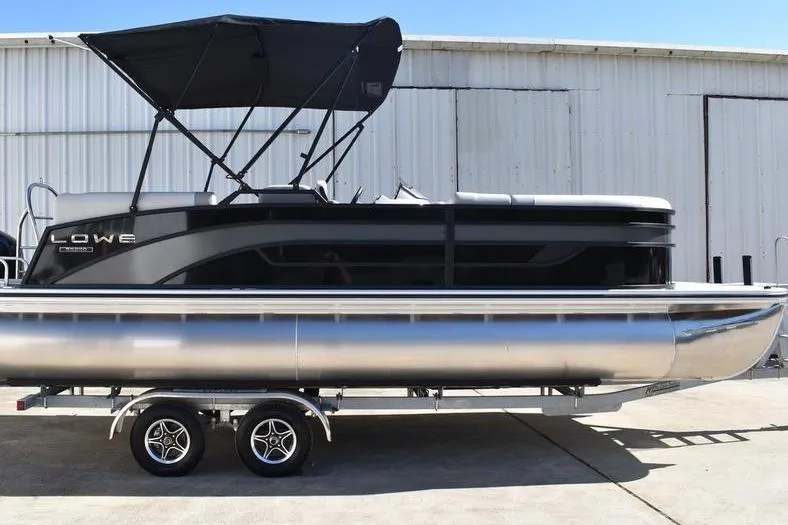 Slide: The Image of 2026 Lowe SS 230 pontoon boat on trailer, featuring sleek design and canopy. - 7