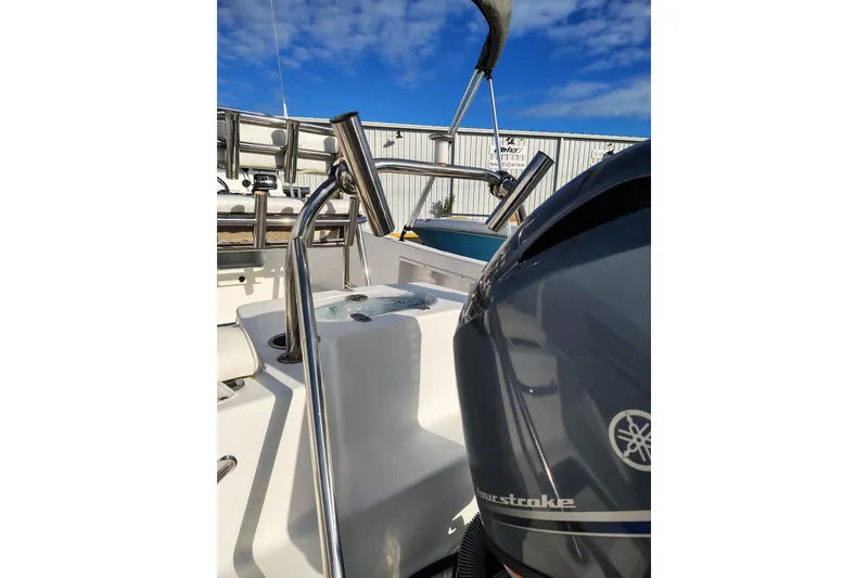 Slide: The Image of 2017 Sea Hunt Triton 188 boat with Yamaha outboard motor, stainless steel railings, and clear sky. - 14