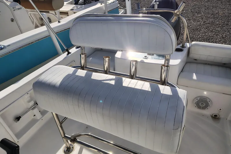 Slide: The Image of 2017 Sea Hunt Triton 188 boat interior with white cushioned seating and stainless steel fixtures. - 15