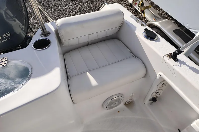 Slide: The Image of 2017 Sea Hunt Triton 188 boat interior with cushioned seating and Yamaha engine. - 16
