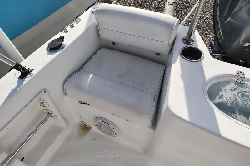 Slide: The Image of White seating area on 2017 Sea Hunt Triton 188 boat with cup holder and livewell. - 17