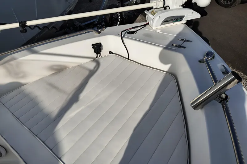 Slide: The Image of 2017 Sea Hunt Triton 188 boat deck with cushioned seating and fishing rod holder. - 19