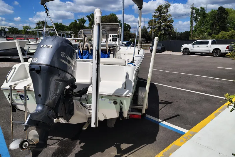 Slide: The Image of 2017 Sea Hunt Triton 188 boat with Yamaha 115 engine in parking lot. - 2