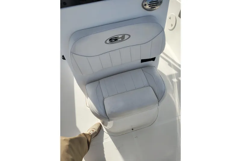 Slide: The Image of White seat on 2017 Sea Hunt Triton 188 boat, featuring logo and speaker. - 23