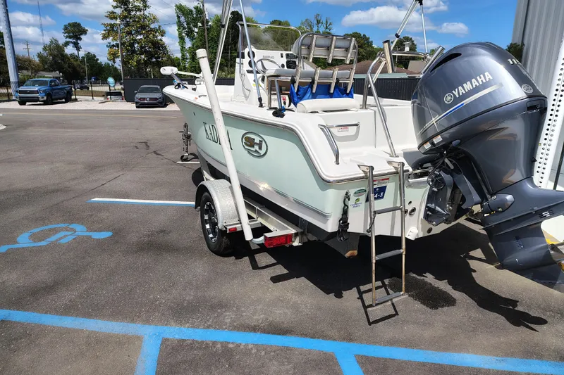 Slide: The Image of 2017 Sea Hunt Triton 188 boat with Yamaha motor in parking lot. - 3