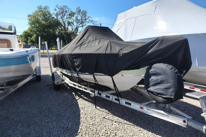 Slide: The Image of 2017 Sea Hunt Triton 188 boat covered on a trailer in a storage area. - 4