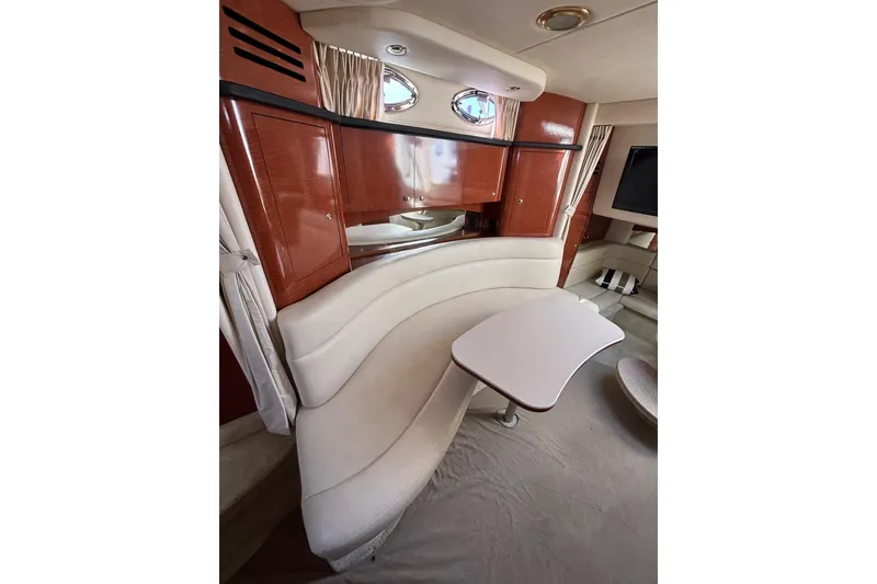 Slide: The Image of Interior of 2003 Sea Ray Sundancer 320 yacht with elegant seating and wooden cabinetry. - 10