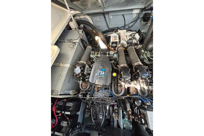 Slide: The Image of Engine compartment of a 2003 Sea Ray Sundancer 320, showcasing mechanical components and wiring. - 16