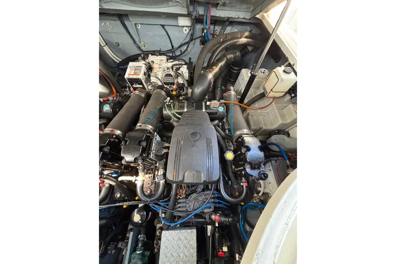 Slide: The Image of Engine compartment of a 2003 Sea Ray Sundancer 320, showcasing mechanical components and wiring. - 17