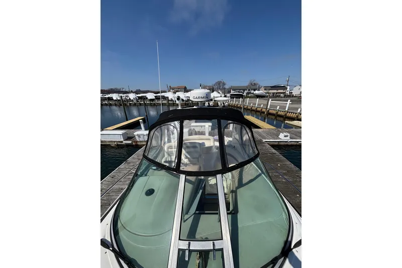 Slide: The Image of 2003 Sea Ray Sundancer 320 docked at a marina under clear blue skies. - 8